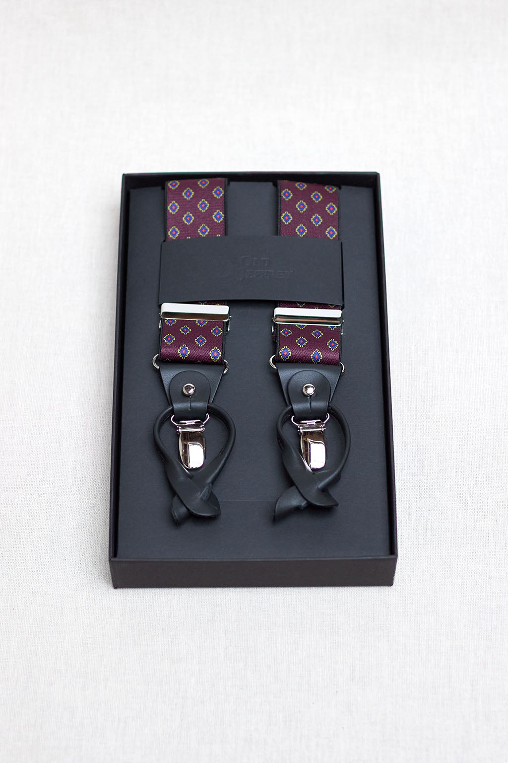 Burgundy Suspenders with Blue and Yellow Rhomboidal Geometry and Black Leather Handles